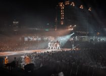 people watching a band performing on stage during nighttime