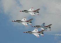 four white jet planes flying during daytime
