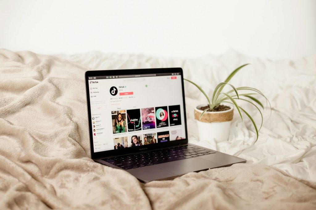 a laptop computer sitting on top of a bed